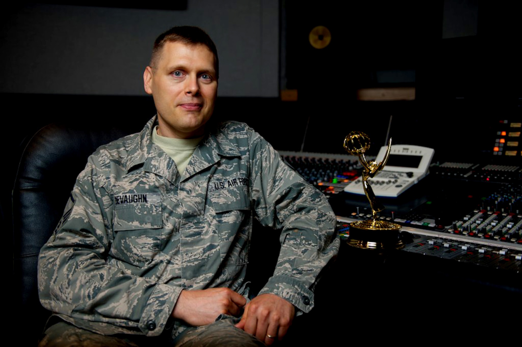 Master Sgt. James DeVaughn smiles for a photo beside his regional Emmy® trophy July 3, 2013, at Bolling Air Force Base, in Washington, D.C. DeVaughn is an audio engineer and production assistant for The U.S. Air Force Band and received the award for his contributions to the live audio of a Veteran's Day concert, broadcast on Nov. 11, 2012. (U.S. Air Force photo/Airman 1st Class Alexander W. Riedel)