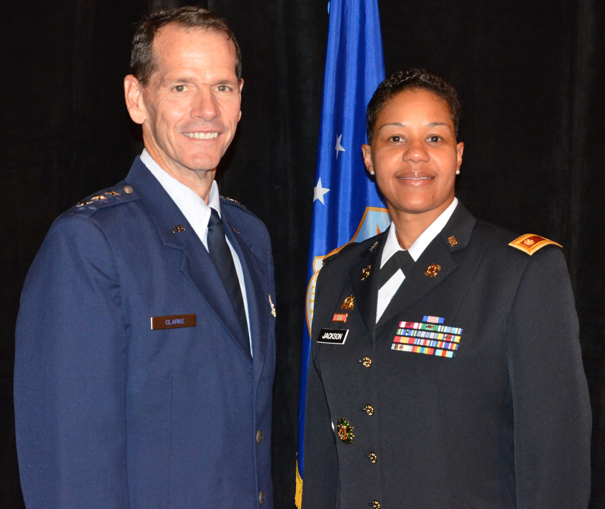 Director of the Air National Guard Lt. Gen. Stanley E. Clarke III (left) congratulates Roy Wilkins Renowned Service Award recipient Maj. Nathlon Jackson during an Armed Services and Veterans Affairs Awards luncheon in Orlando, Fla., July 16, 2013. Photo by Master Sgt. Thomas Kielbasa