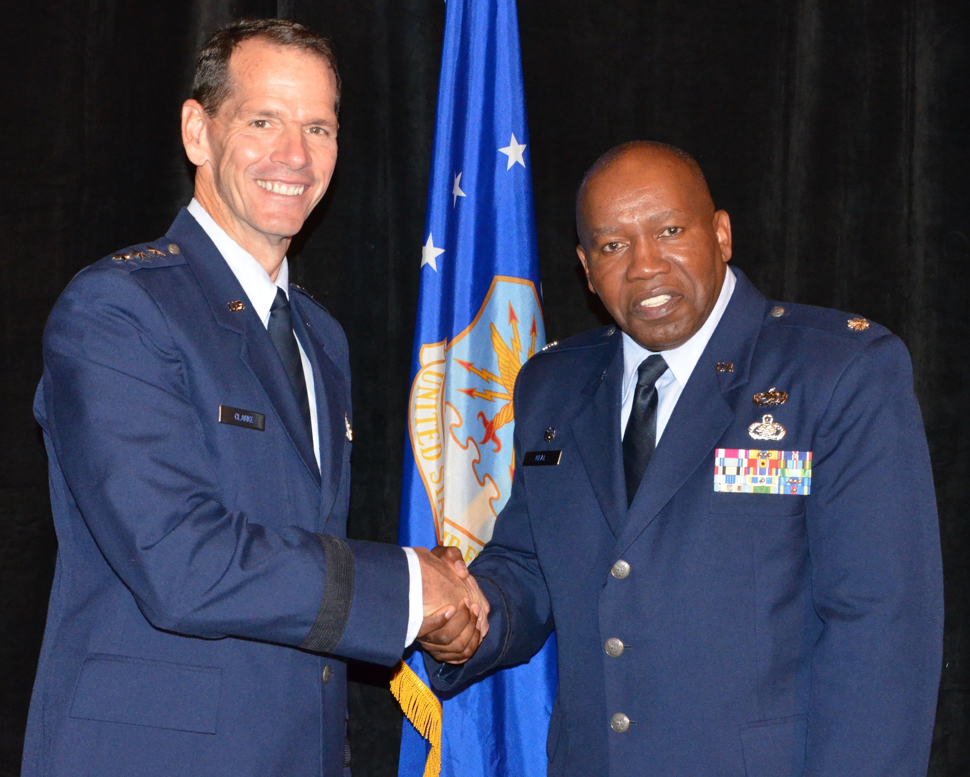 Director of the Air National Guard Lt. Gen. Stanley E. Clarke III (left) congratulates Roy Wilkins Renowned Service Award recipient Lt. Col. Anderson Neal Jr. during an Armed Services and Veterans Affairs Awards luncheon in Orlando, Fla., July 16, 2013. Photo by Master Sgt. Thomas Kielbasa