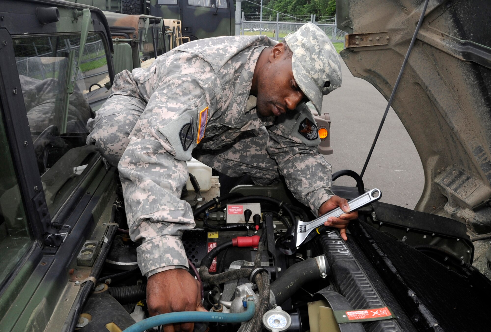 U.S. Army Spc. Ahmed Boyd, Delta Detachment 1st Base Company Joint Tactical Ground Station mechanic, conducts maintenance on a Humvee at Misawa Air Base, Japan, July 17, 2013. Should a crisis situation arise, JTAGS must be capable of mobility. (U.S. Air Force photo by Airman 1st Class Kaleb Snay)