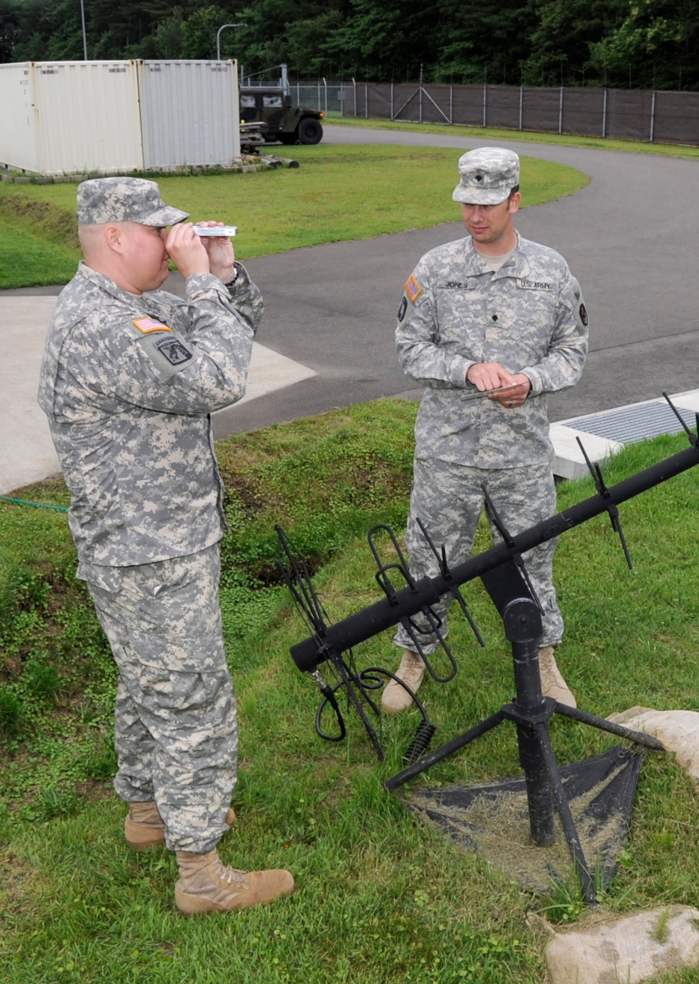 U.S. Army Cpl. Hans Heyer, Delta Detachment 1st Base Company Joint Tactical Ground Station operator, left, and Spc. Randy Jones, Delta Detachment 1st Base Company JTAGS operator, identify satellite locations at Misawa Air Base, Japan, July 17, 2013. The primary mission of early warning system operators is to receive and process in theater direct downlink data from Defense Satellite Program sensors in order to disseminate warning information on ballistic missiles and other tactical events of interest. (U.S. Air Force photo by Airman 1st Class Kaleb Snay)