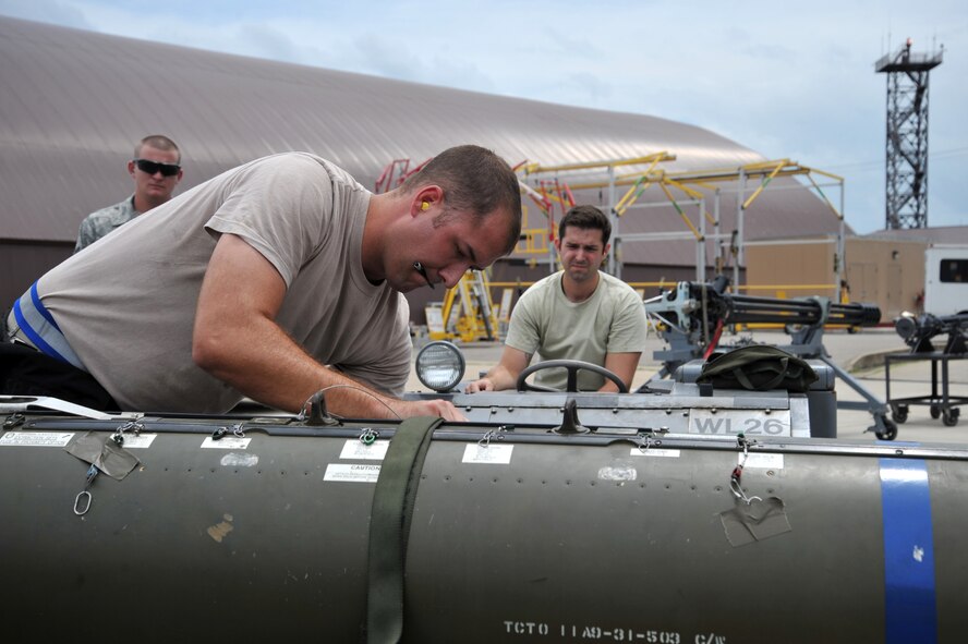 Staff Sgt. Joshua Martin and Senior Airman Joseph Garlick, 55th Aircraft Maintenance Unit weapons loaders, prepare to lift a CBU-103 bomb onto an F-16 Fighting Falcon during a quarterly weapons load crew competition at Osan Air Base, Republic of Korea, July 19, 2013. During a competition, each member has a set of tasks to carry out and work in teams of three or four, depending on the aircraft. (U.S. Air Force photo/Staff Sgt. Emerson Nuñez)