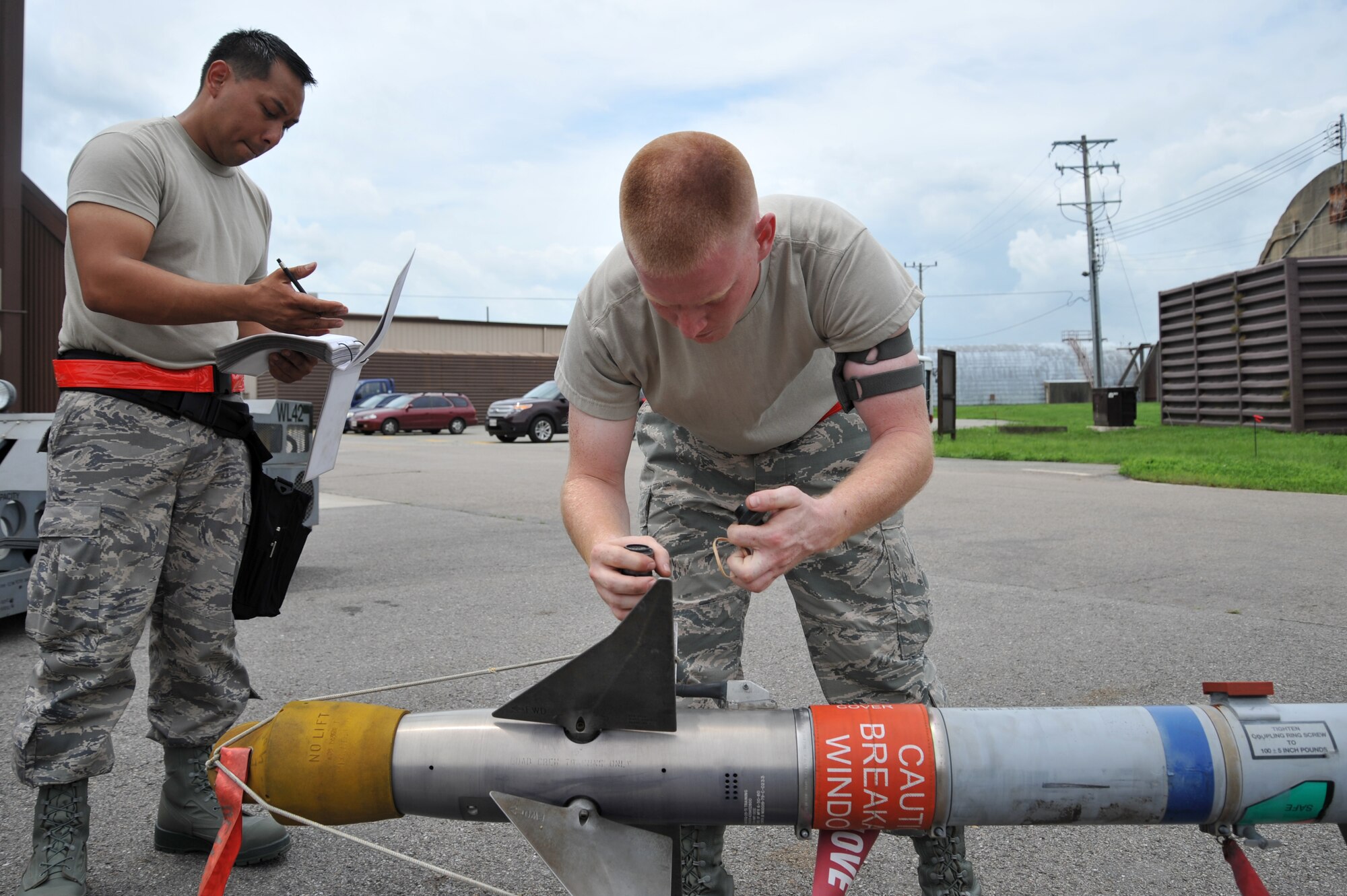 Airman 1st Class Douglas Edmondson, 36th Aircraft Maintenance Unit weapons loader, prepares an AIM-9 Sidewinder missile to be loaded onto an F-16 Fighting Falcon during a quarterly weapons load crew competition at Osan Air Base, Republic of Korea, July 19, 2013. Load crew competitions are held to give weapons personnel the opportunity to display their war-fighting skills and unveils the best weapons load crew for a particular quarter during the year. (U.S. Air Force photo/Staff Sgt. Emerson Nuñez)