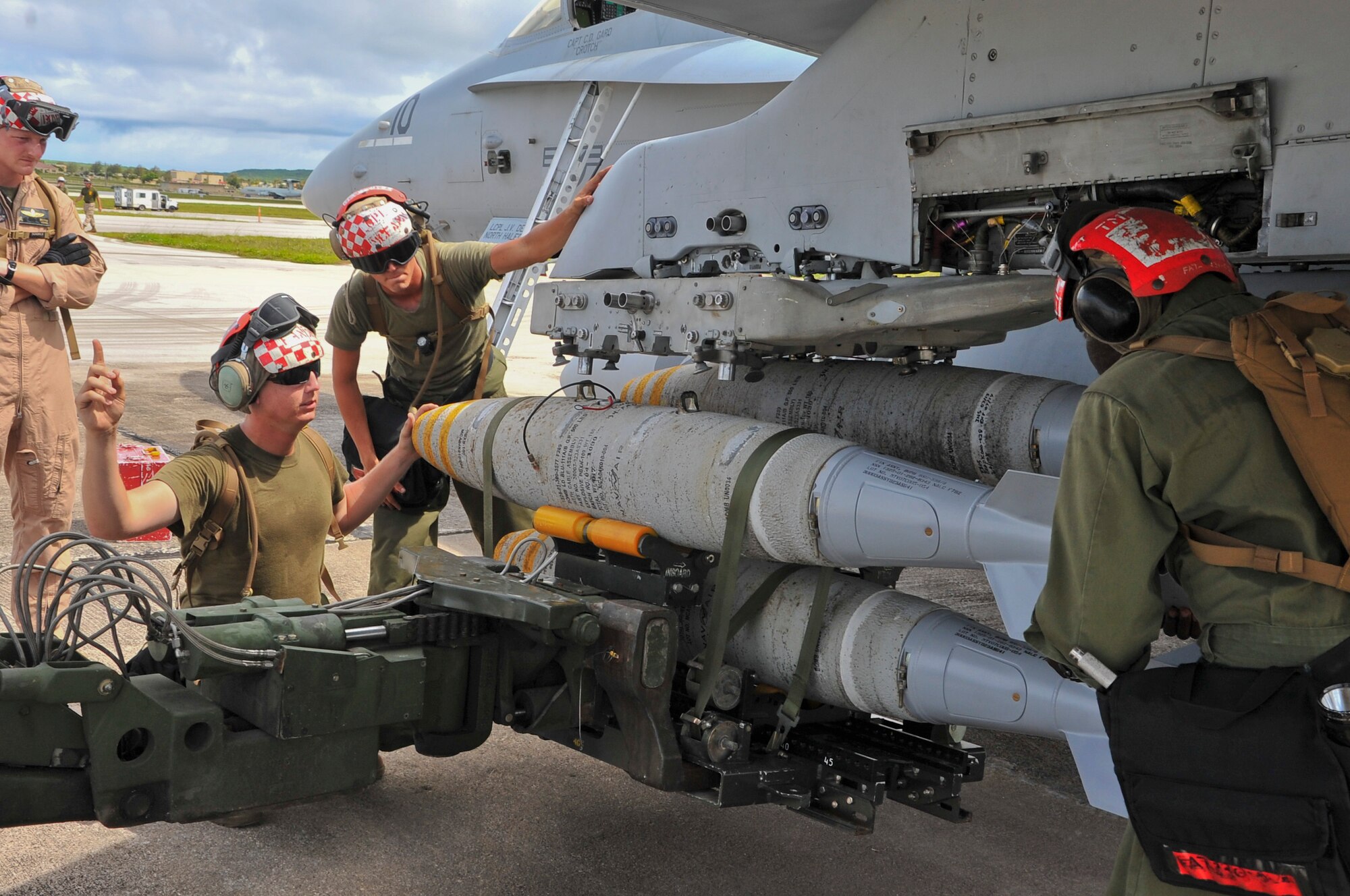 U.S. Marines deployed from the 533rd All-Weather Fighter Attack Squadron at U.S. Marine Corps Air Station Beaufort, S.C., load munitions on a F/A-18D Hornet on Andersen Air Force Base, Guam, July 19, 2013. The unit is on Andersen to take advantage of the area’s unique training ranges. (U.S. Air Force photo by Airman 1st Class Adarius Petty/Released)