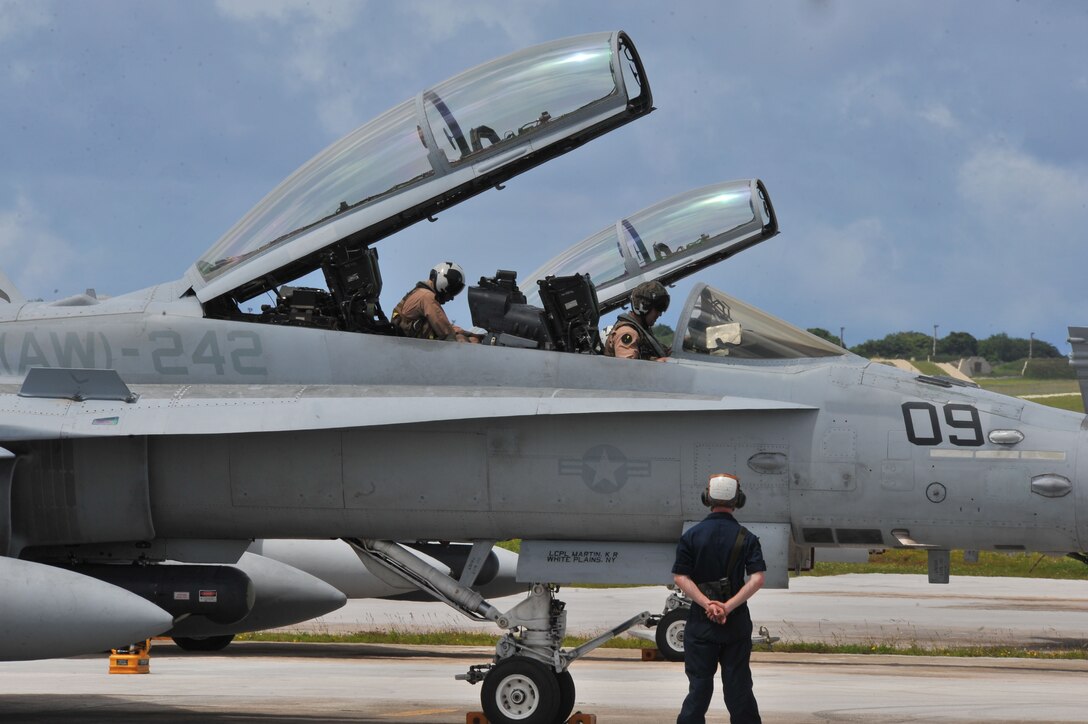 U.S. Marines deployed from the 533rd All-Weather Fighter Attack Squadron at U.S. Marine Corps Air Station Beaufort, S.C.,  inspect a F/A-18D Hornet on Andersen Air Force Base, Guam, July 19, 2013. The unit is on Andersen to take advantage of the area’s unique training ranges. (U.S. Air Force photo by Airman 1st Class Adarius Petty/Released)