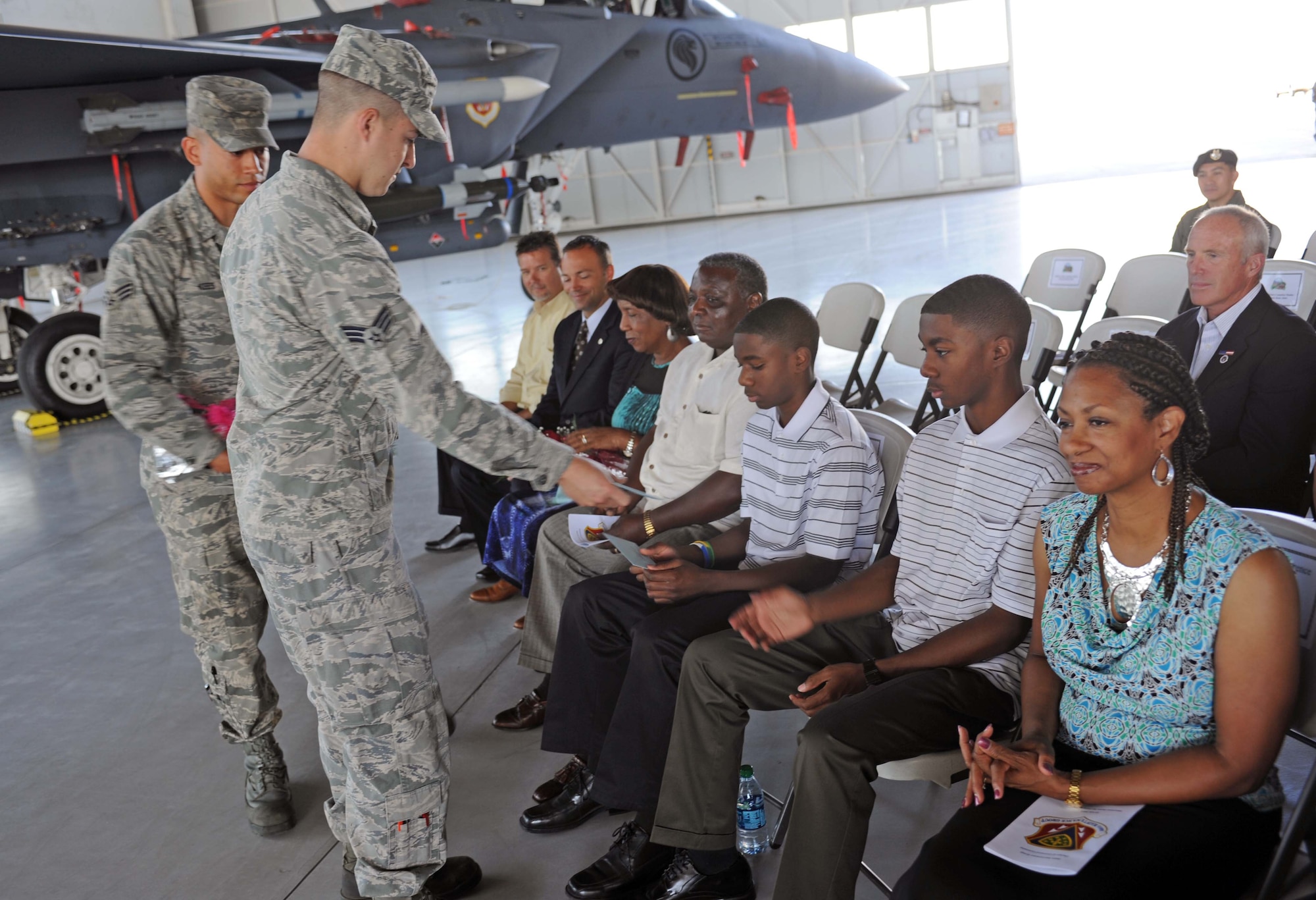 Family members of U.S. Air Force Col. Michael Lawrence, 366th Maintenance Group commander, receive gifts during the change of command ceremony July 22, 2013, at Mountain Home Air Force Base, Idaho. Lawrence is a 1991 graduate of the U.S. Air Force Academy, Colorado Springs, Colo. (U.S. Air Force photo by Senior Airman Benjamin Sutton/Released)