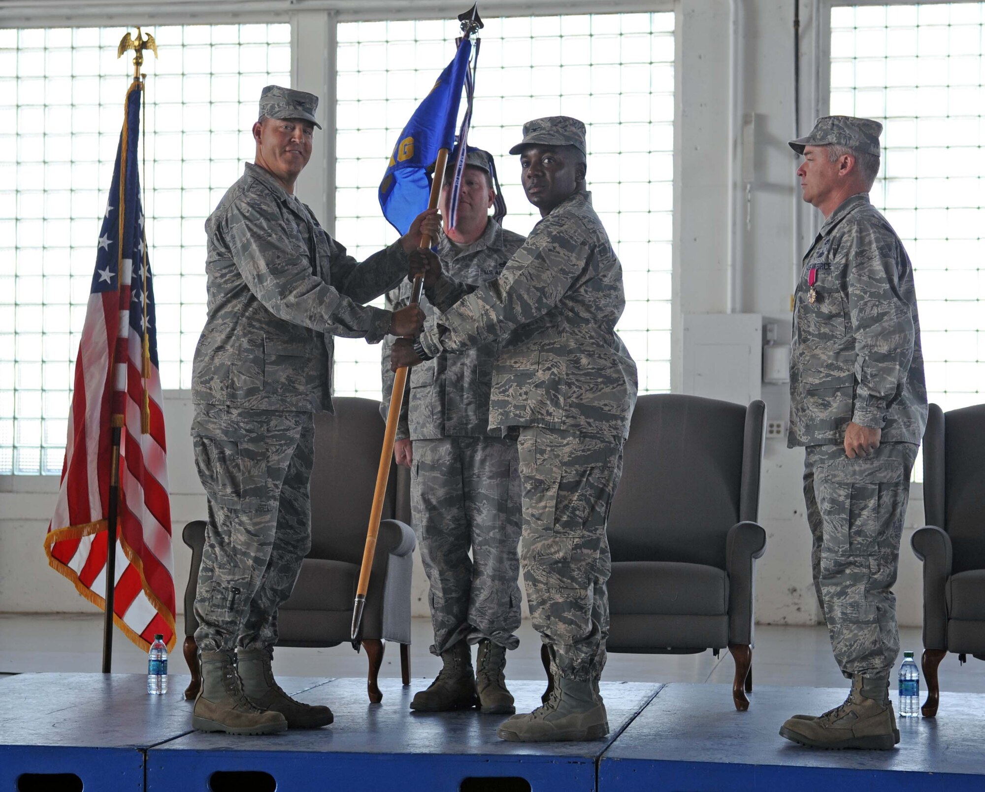 From left, U.S. Air Force Col. Chris Short, 366th Fighter Wing commander, gives the 366th Maintenance Group guidon to Col. Michael Lawrence, 366th MXG in-coming commander, July 22, 2013, at Mountain Home Air Force Base, Idaho. Lawrence was formerly the deputy commander of the 432nd MXG at Creech Air Force Base, Nev. (U.S. Air Force photo by Senior Airman Benjamin Sutton/Released)