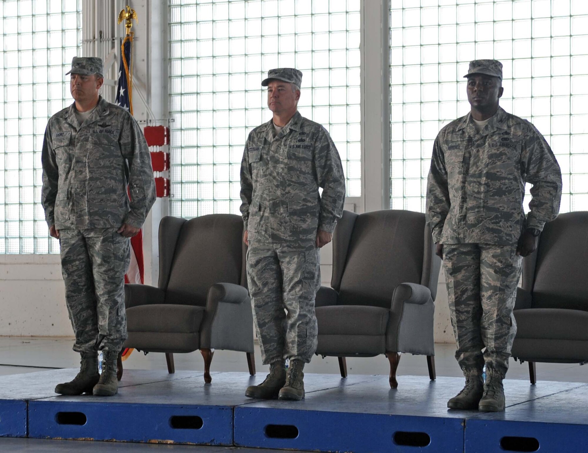From left, U.S. Air Force Col. Chris Short, 366th Fighter Wing commander, Col. James McClellan, 366th Maintenance Group out-going commander, and Col. Michael Lawrence, 366th MXG in-coming commander, stand during the posting of the colors July 22, 2013, at Mountain Home Air Force Base, Idaho. Lawrence comes to MHAFB from Creech Air Force Base, Nev. (U.S. Air Force photo by Senior Airman Benjamin Sutton/Released)