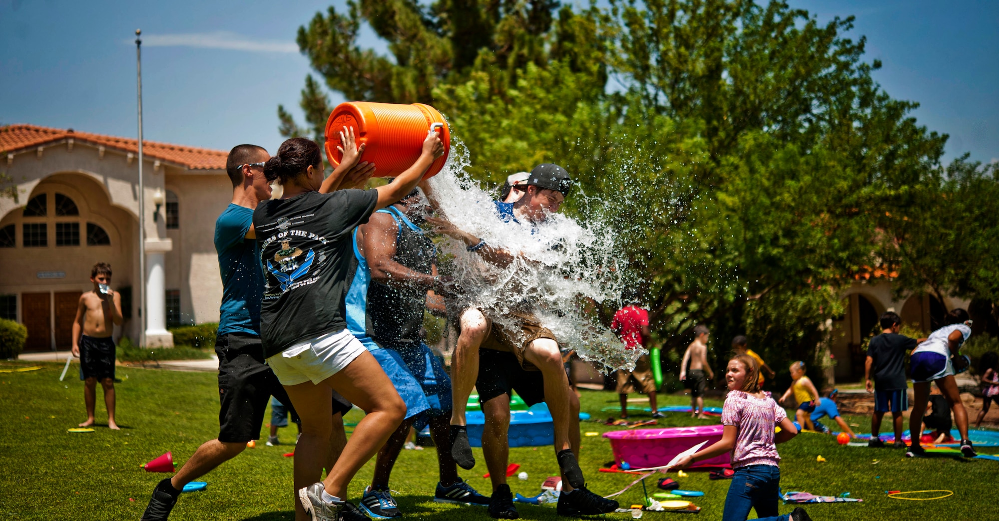 Airmen from the 57th Aircraft Maintenance Squadron Tomahawk Aircraft Maintenance Unit pour water on a resident of the St. Jude’s Ranch for Children July 19, 2013, in Boulder City, Nev. The Airmen played water sports and games with more than 60 residents. (U.S. Air Force photo by Senior Airman Daniel Hughes)
