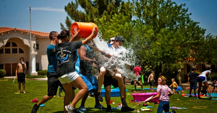 Airmen from the 57th Aircraft Maintenance Squadron Tomahawk Aircraft Maintenance Unit pour water on a resident of the St. Jude’s Ranch for Children July 19, 2013, in Boulder City, Nev. The Airmen played water sports and games with more than 60 residents. (U.S. Air Force photo by Senior Airman Daniel Hughes)
