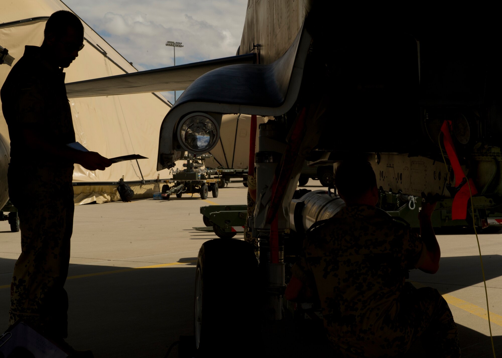 German Air Force Staff Sgt. Esser Benjamin and Airman 1st Class Enrico Reich, German Air Force Flying Training Center weapons load crew members, review a checklist in preparation to load an inert missile onto a Tornado aircraft during a quarterly load crew competition at Holloman Air Force Base, N.M., July 19. The GAF competed in the load crew competition to have their skills evaluated alongside F-22 Raptor aircraft and MQ-9 Reaper aircraft load crews. For the competition, points are awarded during the weapons-loading, tool kit inspection, and uniform inspection. (U.S. Air Force photo by Airman 1st Class Chase Cannon/Released)
