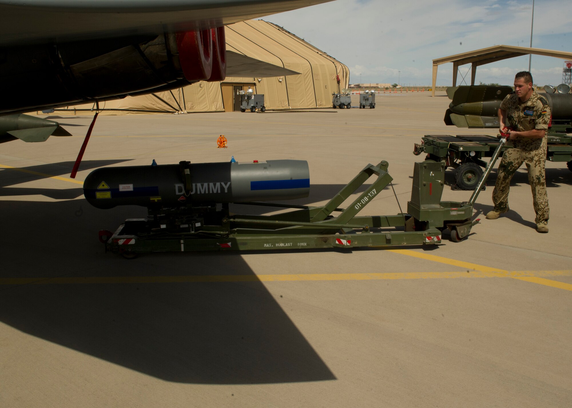 German Air Force Staff Sgt. Mark Bender, German Air Force Flying Training Center weapons load crew member, prepares to raise an inert missile to be loaded onto a Tornado aircraft during a quarterly load crew competition at Holloman Air Force Base, N.M., July 19. The GAF participated in the load-crew competition to have their skills evaluated alongside F-22 Raptor aircraft and MQ-9 Reaper aircraft load crews. For the competition, points are awarded during the weapons-loading, tool kit inspection, and uniform inspection. (U.S. Air Force photo by Airman 1st Class Chase Cannon/Released)