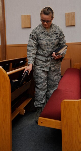 Senior Airman Alisha Smith, 2nd Bomb Wing Chaplain's Assistant, organizes religious materials in preparation for mass at Chapel 2 on Barksdale Air Force Base, La., July 22, 2013. Chaplains and Chaplain's Assistants perform duties such as visitations to various squadrons to check on Airmen's morale and well-being. (U.S. Air Force photo/Airman 1st Class Andrew Moua)