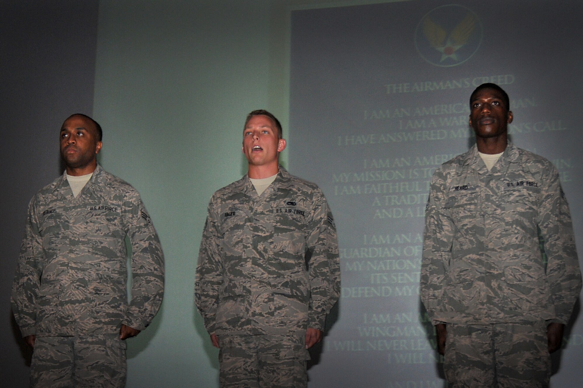 Senior Airman John Hauer, center recites the Airman’s Creed as Senior Airmen Davon Distance and        Laurice Heard wait their turn during a back-to-basics challenge at Dover Air Force Base, Del., July 14, 2013. All three Airmen are reservists assigned to the 712th Aircraft Maintenance Squadron, and Hauer won the Airman’s Creed competition helping propel his unit to victory. (U.S. Air Force photo/Senior Airman Joe Yanik)
