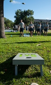 Airman 1st Class Zachary Huffman, 628th Logistics Readiness Squadron Petroleum Oil and Lubricants fuels distribution, tosses a bean bag during a corn hole game July 19, 2013, at the Dorm Challenge at Joint Base Charleston - Air Base, S.C. The quarterly competition is a Wing initiative intended to encourage resident interaction and camaraderie as part of Comprehensive Airman Fitness.  The Dorm Challenge consisted of push-ups, sit-ups, and games of cornhole and basketball. (U.S. Air Force photo/Senior Airman Ashlee Galloway)