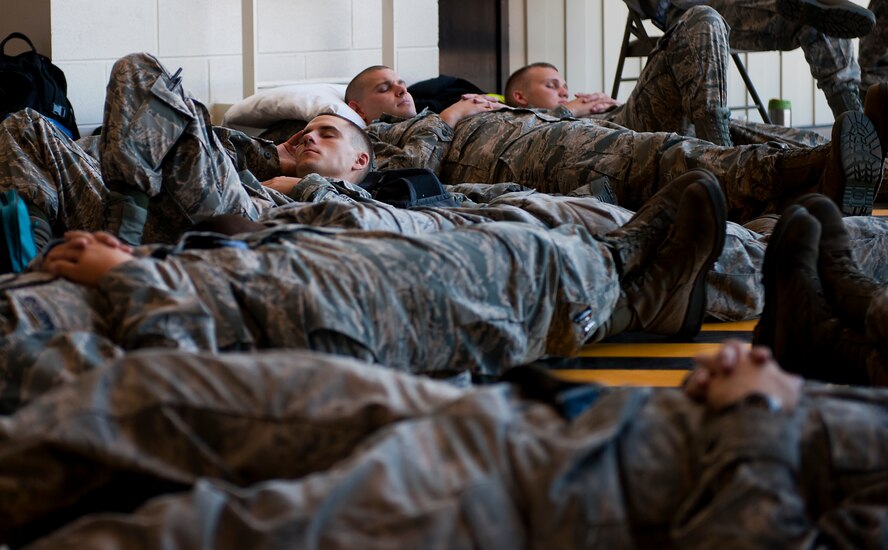 Dyess Airmen find a moment to rest prior to deploying to Southwest Asia July 19, 2013, at Dyess Air Force Base, Texas. More than 300 servicemembers from the 9th Bomb Squadron (BS), 7th Aircraft Maintenance Squadron, 7th Munitions Squadron and 7th Operations Support Squadron deployed in support of U.S. Air Force Central Command. (U.S. Air Force photo by Airman 1st Class Damon Kasberg/Released)