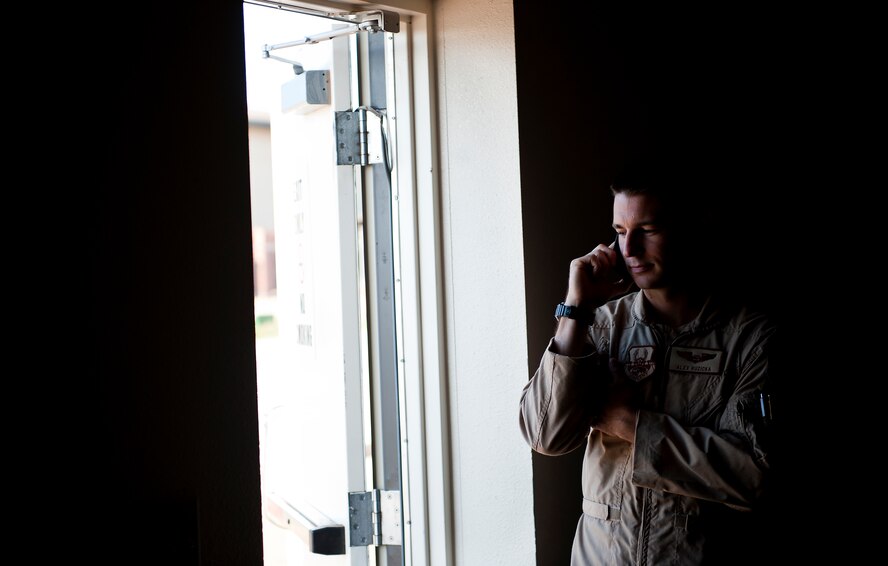 U.S. Air Force 1st Lt. Alex Ruzicka, 9th Bomb Squadron (BS), talks to his father prior to deploying to Southwest Asia July 19, 2013, at Dyess Air Force Base, Texas. More than 300 servicemembers from the 9th BS, 7th Aircraft Maintenance Squadron, 7th Munitions Squadron and 7th Operations Support Squadron deployed in support of U.S. Air Force Central Command. (U.S. Air Force photo by Airman 1st Class Damon Kasberg/Released)