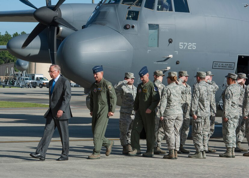 Distinguished visitors Sam Nunn, former U.S. Senator, U.S. Air Force Maj. Gen. Jake Polumbo, 9th Air Force commander, and Col. Chad Franks, 23d Wing commander, exit an HC-130J Combat King II through a formation of Airmen rendering salutes at Moody Air Force Base, Ga., July 19, 2013. Nunn and Polumbo spoke during the official arrival ceremony of Moody’s first HC-130J model, an aircraft which will replace the HC-130P Combat King that has been in service for more than 50 years. (U.S. Air Force photo by Senior Airman Eileen Meier/Released)