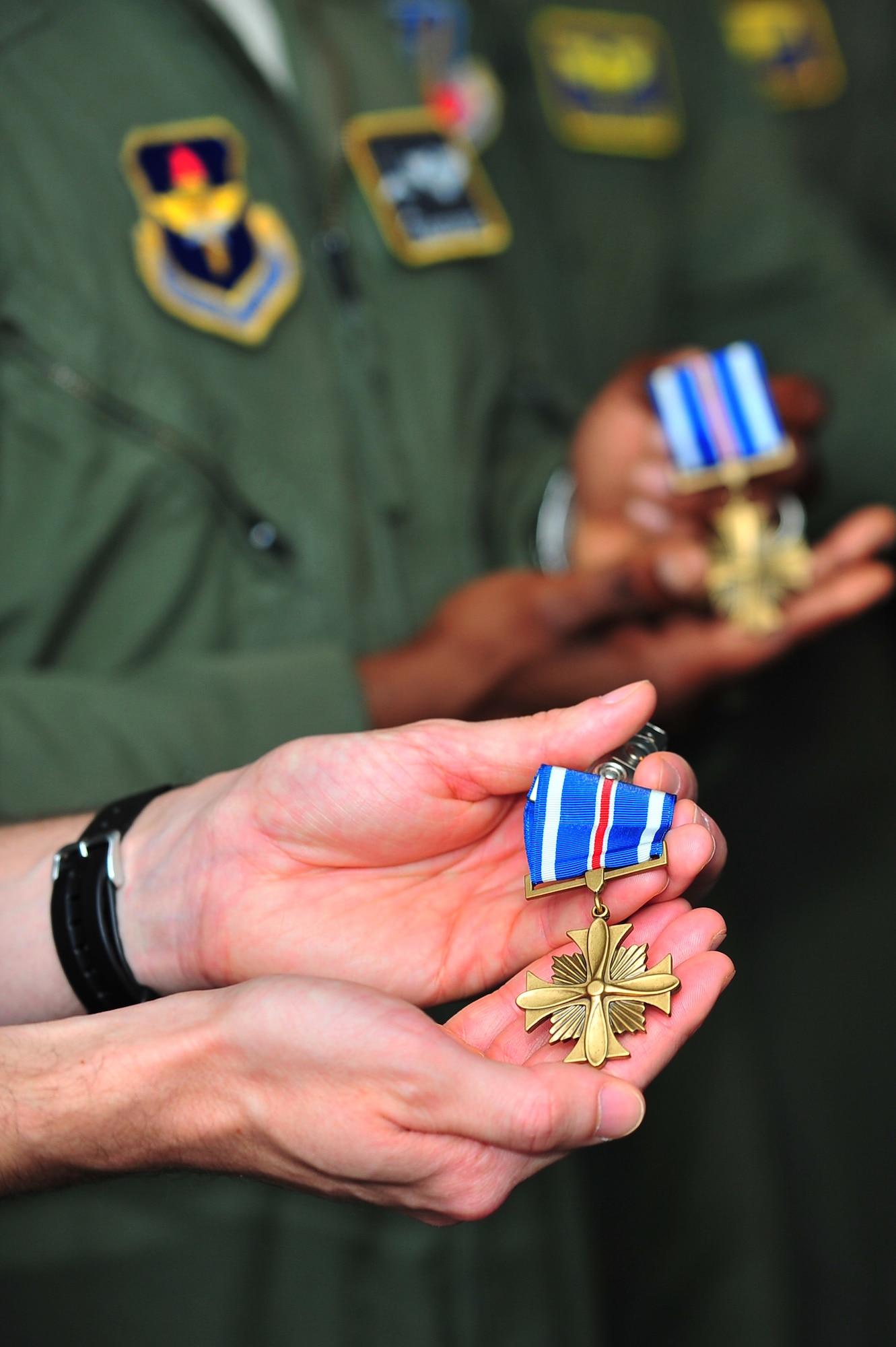 U.S. Air Force F-15E Strike Eagle pilots and weapon systems officers assigned to the 4th Fighter Wing and 366th FW, Mountain Home Air Force Base, Idaho, display their Distinguished Flying Cross medals during a ceremony at Seymour Johnson Air Force Base, N.C., July 19, 2013. Seven Airmen were presented the medals for saving countless lives of Libyan citizens while supporting Operation ODYSSEY DAWN in 2011. (U.S. Air Force photo by Senior Airman Aubrey White/Released)