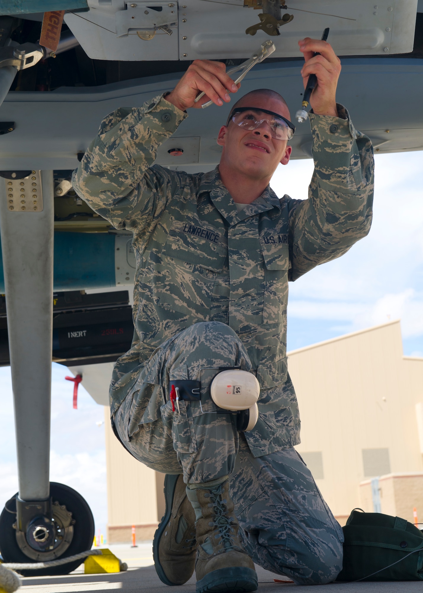 Airman 1st Class Robert Lawrence, 849th Aircraft Maintenance Squadron weapons load crew member, cuts wire on the MQ-9 Reaper during the second quarter load crew competition at Holloman Air Force Base, N.M., July 19. The MQ-9 load crew participated in the load crew competition to have their skills evaluated alongside the F-22 Raptor and German Air Force Tornado aircraft load crews. For the competition, points are awarded during the weapons loading, tool kit inspection, and uniform inspection. (U.S. Air Force photos by Airman 1st Class Leah Murray/Released)