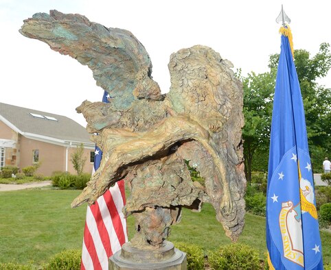 A bronze sculpture named The Angel and the Dying Unknown created by Greg Wyatt was unveiled in the meditation garden near the Fisher House July 22, 2013 at Dover Air Force Base, Del. The sculpture was donated by the Newington-Cropsey Foundation, an organization that focuses on preserving and displaying art. (U.S. Air Force photo/Greg L. Davis) 
