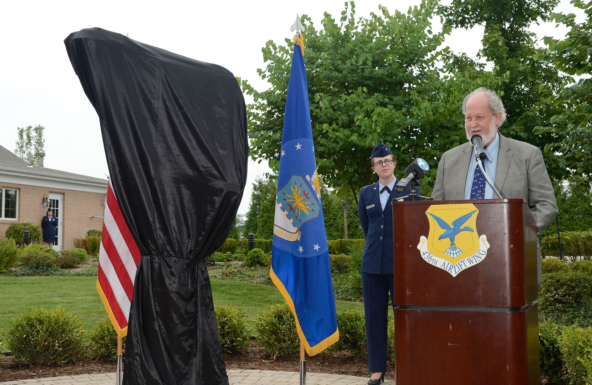 Mr. Greg Wyatt, sculptor of The Angel and the Dying Unknown bronze sculptur speaks at the unveiling ceremony near the Fisher House on July 22, 2013 at Dover Air Force Base, Del. The sculpture was donated by the Newington-Cropsey Foundation, an organization that focuses on preserving and displaying art.  (U.S. Air Force photo/Greg L. Davis)
