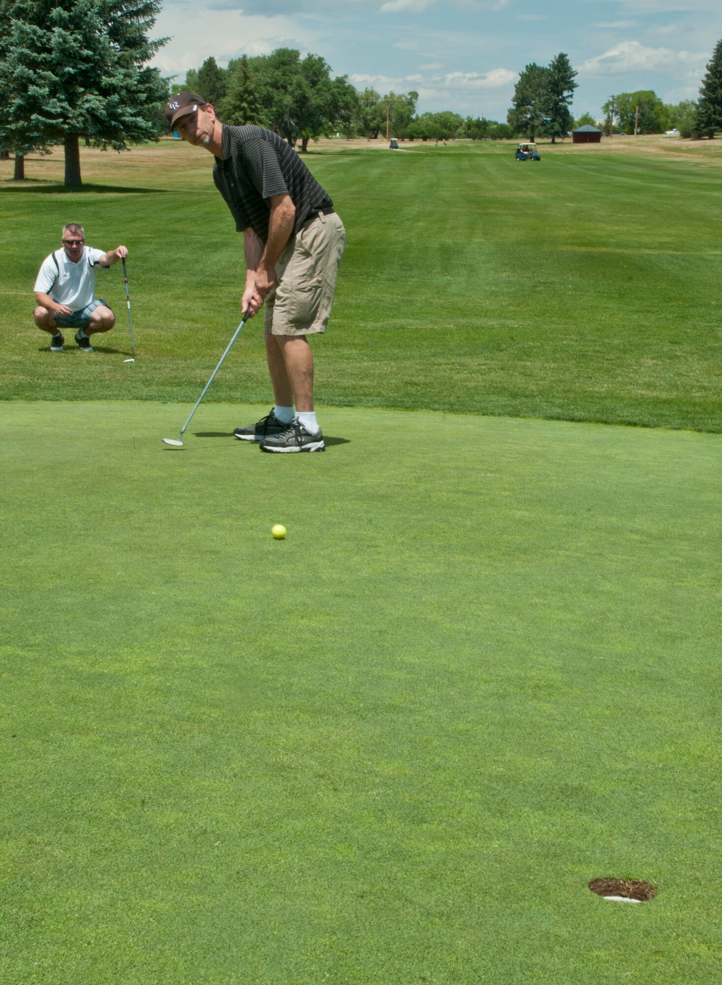 Robert Nisley, Great Lakes Airlines inspector supervisor, putts during the 2013 Military Affairs Committee Golf Scrambler Tournament July 12, 2013, on the F. E. Warren Golf Course. The Cheyenne Chamber of Commerce MAC invited local business and organization members and F. E. Warren personnel to participate in the tournament to engage in a more relaxed and social setting than the usual formal interactions. Proceeds from the tournament will also go to fund MAC troop support activities, said Nicole Whitaker and Denise Rampolla, co-chairs for the tournament. (U.S. Air Force photo by Airman 1st Class Jason Wiese)