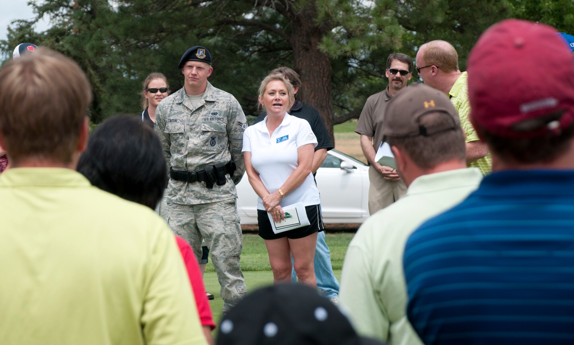 Nicole Whitaker, 2013 Military Affairs Committee Golf Scrambler Tournament co-chair, explains the rules of the tournament to participating teams July 12, 2013, outside the clubhouse on the F. E. Warren Golf Course. Different holes had special rules. For instance, on Hole 13, golfers wore an eye patch like the Jolly Roger emblem, and on Hole 11, team members were handcuffed together when putting. (U.S. Air Force photo by Airman 1st Class Jason Wiese)