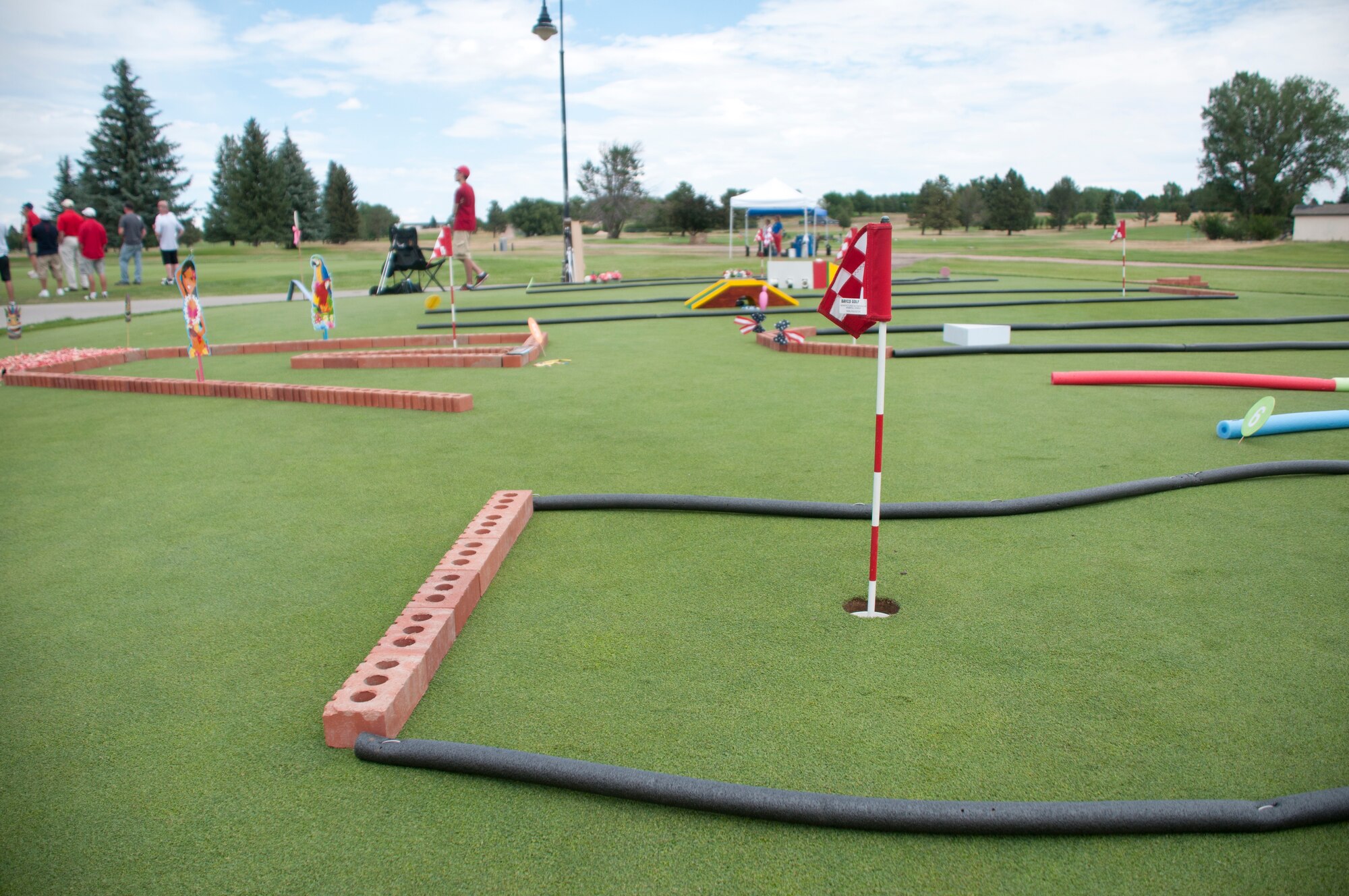 Event organizers set up a putt-putt area specifically for the 2013 Military Affairs Committee Golf Scrambler Tournament July 12, 2013. Participants and guests could be seen practicing putts before taking to the greens on the F. E. Warren Golf Course. (U.S. Air Force photo by Airman 1st Class Jason Wiese)