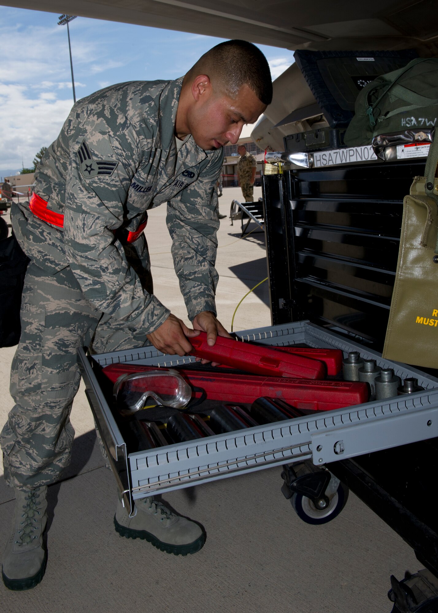 Senior Airman Vincent Miller, 49th Aircraft Maintenance Squadron F-22 Raptor weapons load crew member, puts tools away after loading munitions on the F-22 during the second quarter load crew competition at Holloman Air Force Base, N.M., July 19. The F-22 load crew competed against MQ-9 Reaper and German Air Force load crews. For the competition, points are awarded during the weapons loading, tool kit inspection, and uniform inspection. (U.S. Air Force photo by Senior Airman Kasey Close/Released)