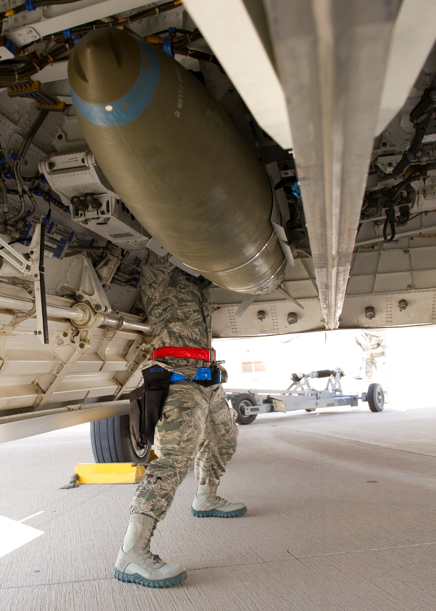 Senior Airman Vincent Miller, 49th Aircraft Maintenance Squadron F-22 Raptor weapons load crew member, inspects an inert GBU-32 Joint Direct Attack Munition bomb ensuring it’s secured during the second quarter load crew competition at Holloman Air Force Base, N.M., July 19. The F-22 load crew competed against MQ-9 Reaper and German Air Force load crews. For the competition, points are awarded during the weapons loading, tool kit inspection, and uniform inspection. (U.S. Air Force photo by Senior Airman Kasey Close/Released)