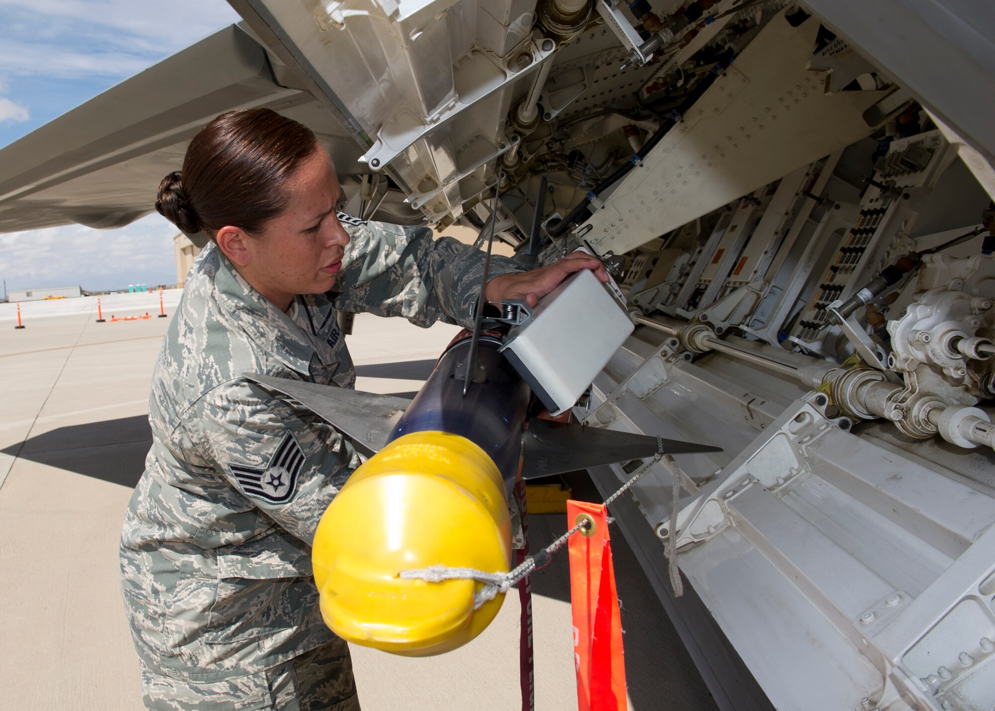 Staff Sgt. Irma Hinton, 49th Aircraft Maintenance Squadron F-22 Raptor weapons load crew member, inspects an inert AIM-9 Sidewinder missile ensuring it’s secured during the second quarter load crew competition at Holloman Air Force Base, N.M., July 19. The F-22 load crew competed against MQ-9 Reaper and German Air Force load crews. The crews are awarded points during the weapons loading, tool kit inspection, and uniform inspection. (U.S. Air Force photo by Senior Airman Kasey Close/Released)
