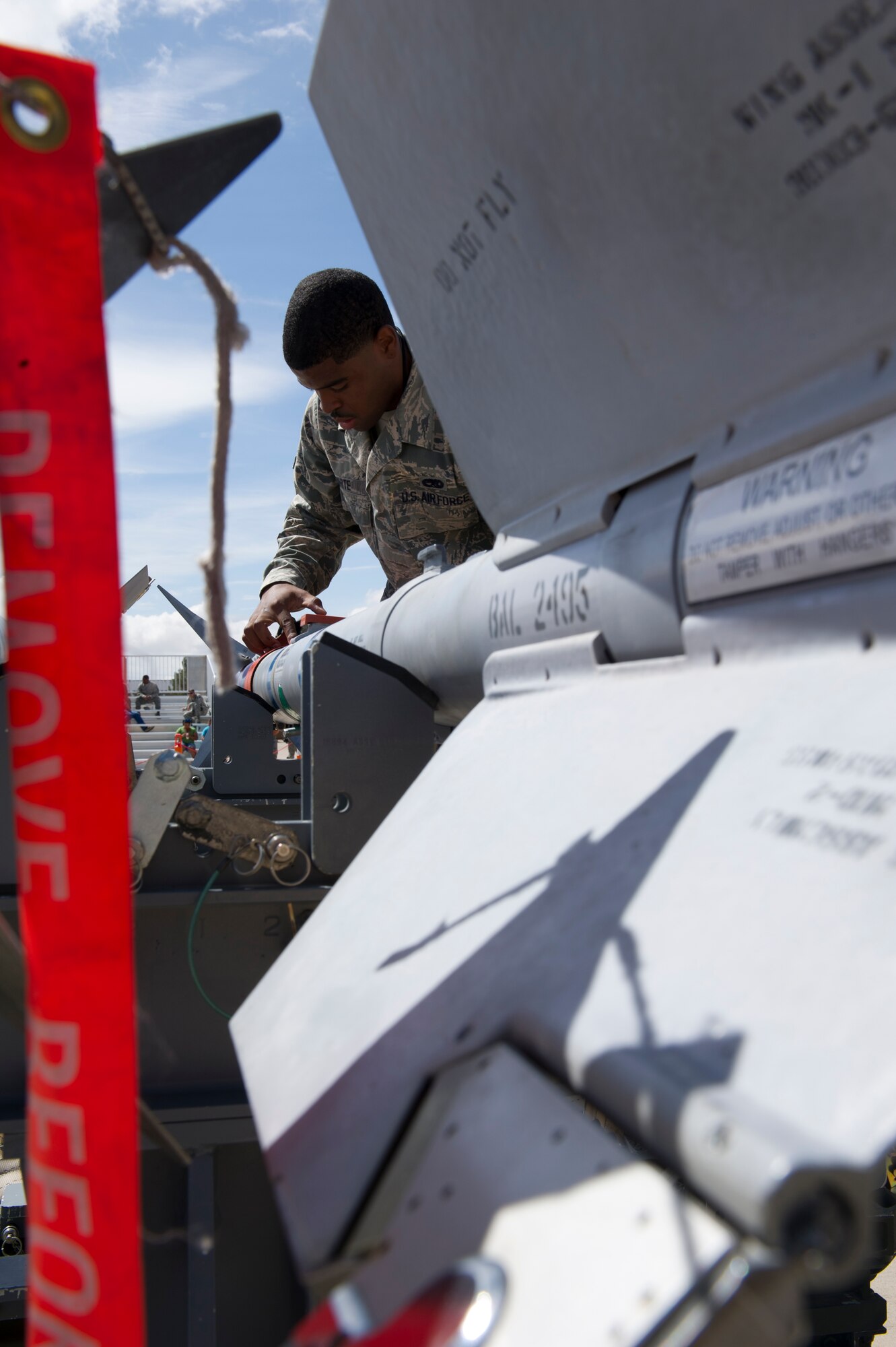 Airman 1st Class Nathan White, 49th Aircraft Maintenance Squadron F-22 Raptor weapons load crew member, inspects an inert AIM-9 Sidewinder missile during the second quarter load crew competition at Holloman Air Force Base, N.M., July 19. The F-22 load crew competed against MQ-9 Reaper and German Air Force load crews. For the competition, points are awarded during the weapons loading, tool kit inspection, and uniform inspection. (U.S. Air Force photo by Senior Airman Kasey Close/Released)
