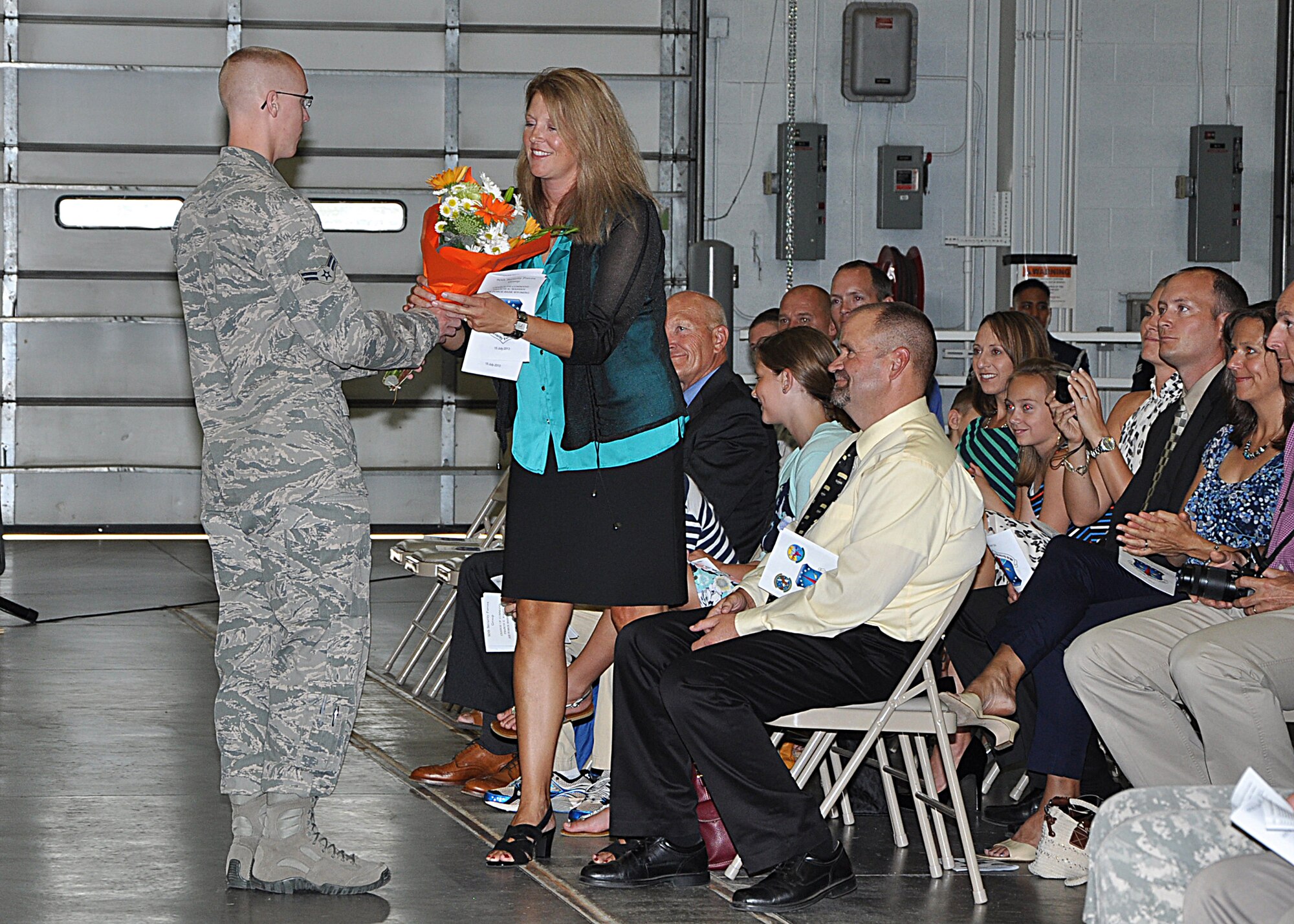 Starry Allton, spouse of Col. Craig Allton, newly appointed commander of the 90th Security Forces Group, receives a bouquet of flowers on behalf of the 90th SFG July 15, 2013, during the 90th SFG change of command. (U.S. Air Force photo by Senior Airman Mike Tryon)
