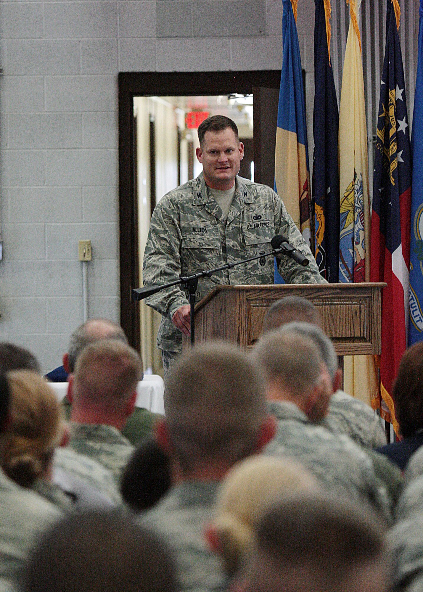 Col. Craig Allton, 90th Security Forces Group, speaks to the crowd in Bldg. 1501 July 15, 2013, after assuming command of the group. (U.S. Air Force photo by Matt Bilden)