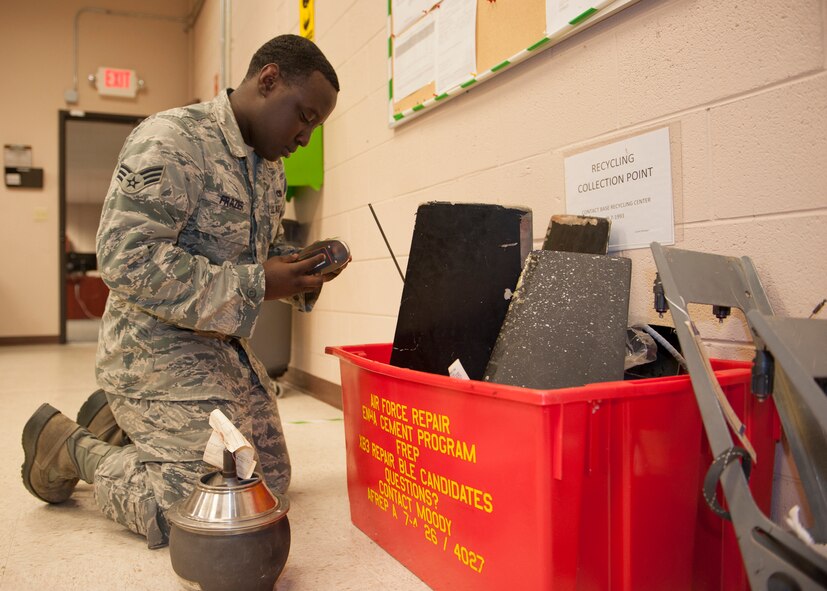 U.S. Air Force Senior Airman Quentez Frazier, 23d Maintenance Group Air Force Repair Enhancement Program (AFREP) technician, disposes of equipment in a drop-off point for un-repairable damaged equipment at Moody Air Force Base, Ga., July 17, 2013. AFREP aims to repair government equipment that would otherwise be replaced. (U.S. Air Force photo by Senior Airman Eileen Meier/Released)