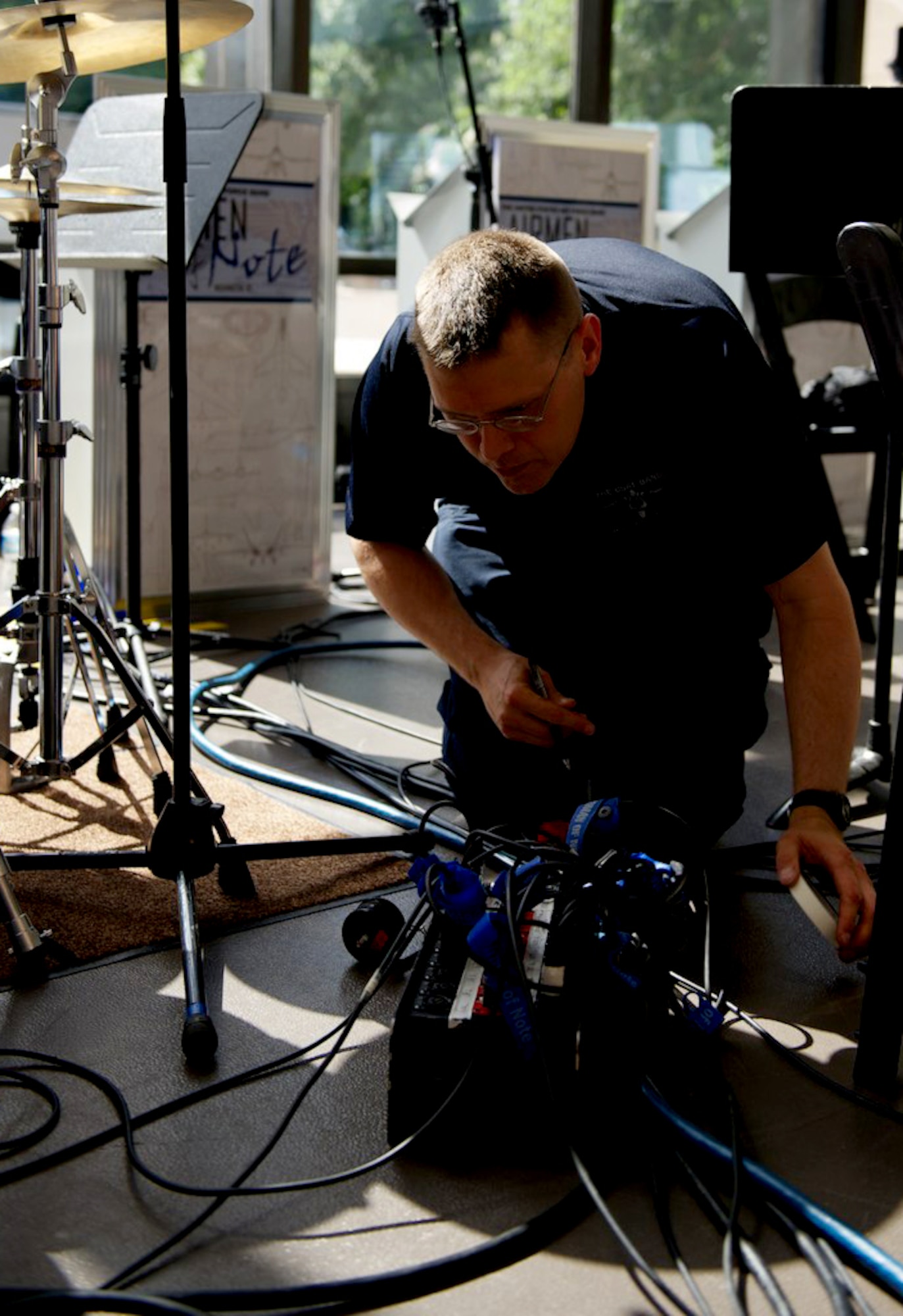Master Sgt. James DeVaughn marks microphone and speaker cables with tape before a live concert of The Airmen of Note, July 4, 2013, at the Smithsonian's National Air and Space Museum in Washington, D.C. DeVaughn is an audio engineer and production assistant with The U.S. Air Force Band, and recently received a regional Emmy® award in recognition of his contribution to the audio recording of a live Veteran's Day concert, which aired Nov. 11, 2012. The Airmen of Note are the premier Jazz ensemble of the U.S. Air Force. (U.S. Air Force photo/Alexander W. Riedel)