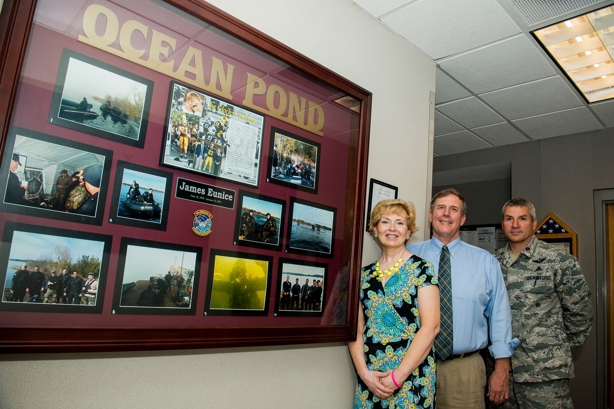 John and Tammy Eunice, and U.S. Air Force Maj. Joseph Barnard, 38th Rescue Squadron commander, pose next to a James Eunice memorial July 10, 2013, at Moody Air Force Base, Ga. The memorial honors James, a 17-year-old who drowned at Ocean Pond while duck hunting in Lake Park, Ga., in January 2011. Airmen from the 38th and 41st Rescue Squadron took part in the rescue effort to recovery James’ body from the pond. (U.S. Air Force photo by Staff Sgt. Jamal D. Sutter/Released)