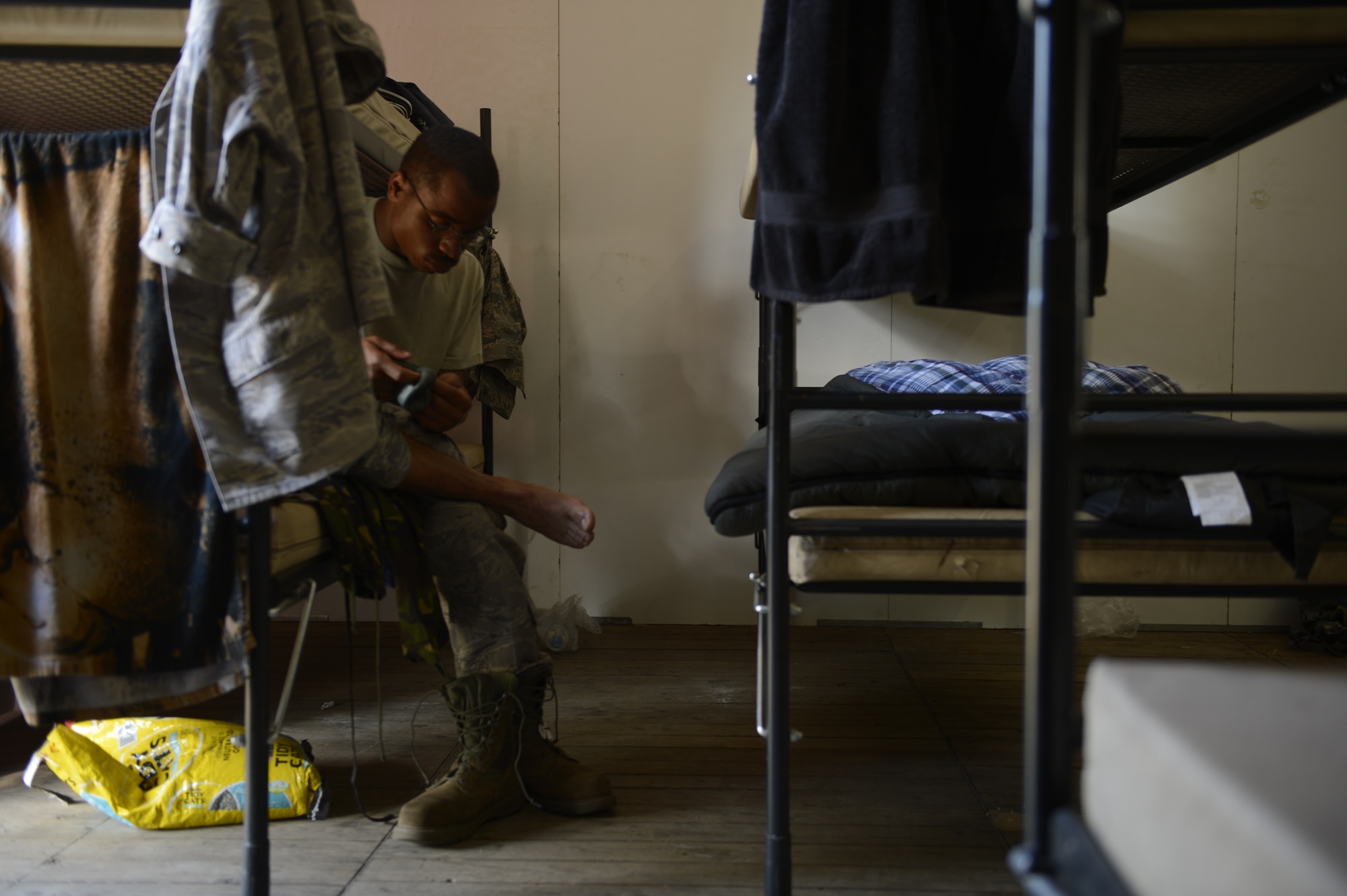 NIJMEGEN, Netherlands -- U.S. Air Force Staff Sgt. Robert Dyer, 52nd Logistic Readiness Squadron International Four Days Marches team member, removes his bandages after the final day of the march July 19, 2013. Dyer was one of the four 52nd LRS team members to complete the march. (U.S. Air Force photo by Senior Airman Natasha Stannard/Released)