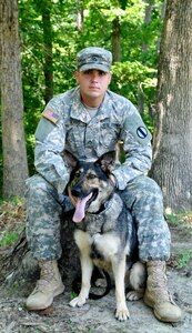 U.S. Army Pfc. Brenan Ward, 3rd Military Police Detachment explosive dog handler, and his MWD Marie, are one of six teams to go through an annual certification course July 15-18 at Fort Eustis, Va. During the course teams demonstrated their ability to perform simple obedience, detection and patrol tasks. (U.S. Air Force photo by Staff Sgt. Wesley Farnsworth/Released)