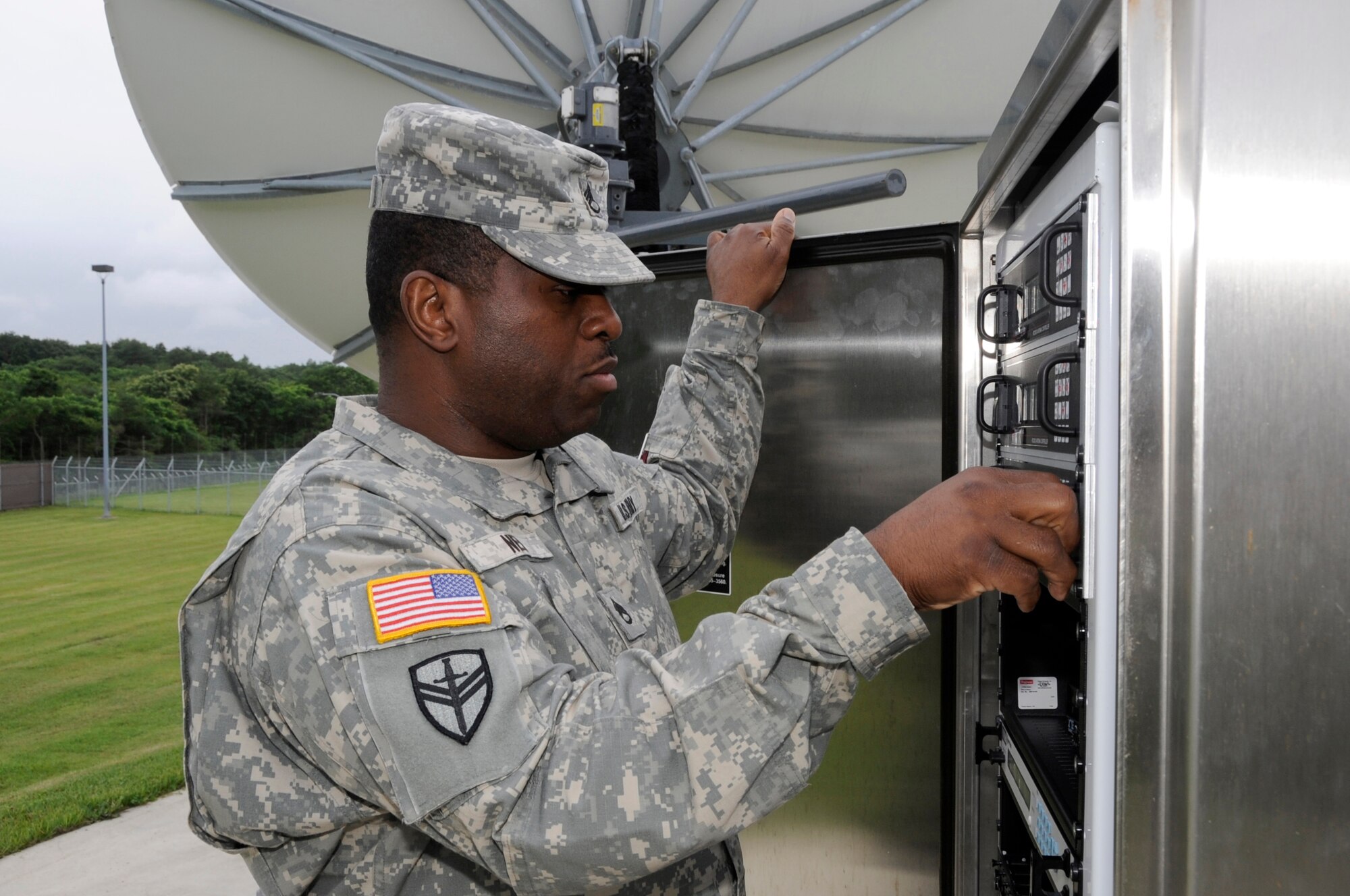 U.S. Army Staff Sgt. Martin Ned, Delta Detachment 1st Base Company Joint Tactical Ground Station crew chief, inspects a commercial antenna at Misawa Air Base, Japan, July 17, 2013. The antennas receive infrared data from several satellites; this information is then carefully monitored by operators that are specially trained to identify anomalies that are possible events of interest. (U.S. Air Force photo by Airman 1st Class Kaleb Snay)