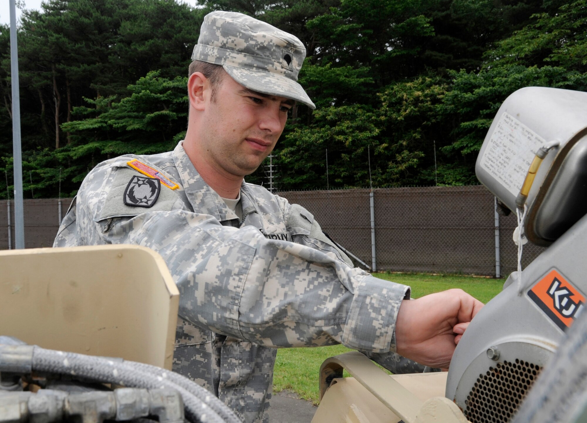 U.S. Army Cpl. Hans Heyer, Delta Detachment 1st Base Company Joint Tactical Ground Station operator, left, and Sgt. Keith Prater, Delta Detachment 1st Base Company JTAGS early warning systems operator, monitor for possible ballistic missiles inside the operational shelter at Misawa Air Base, Japan, July 17, 2013. The mission requires 24-hour monitoring to ensure the safety of the United States and its allies.