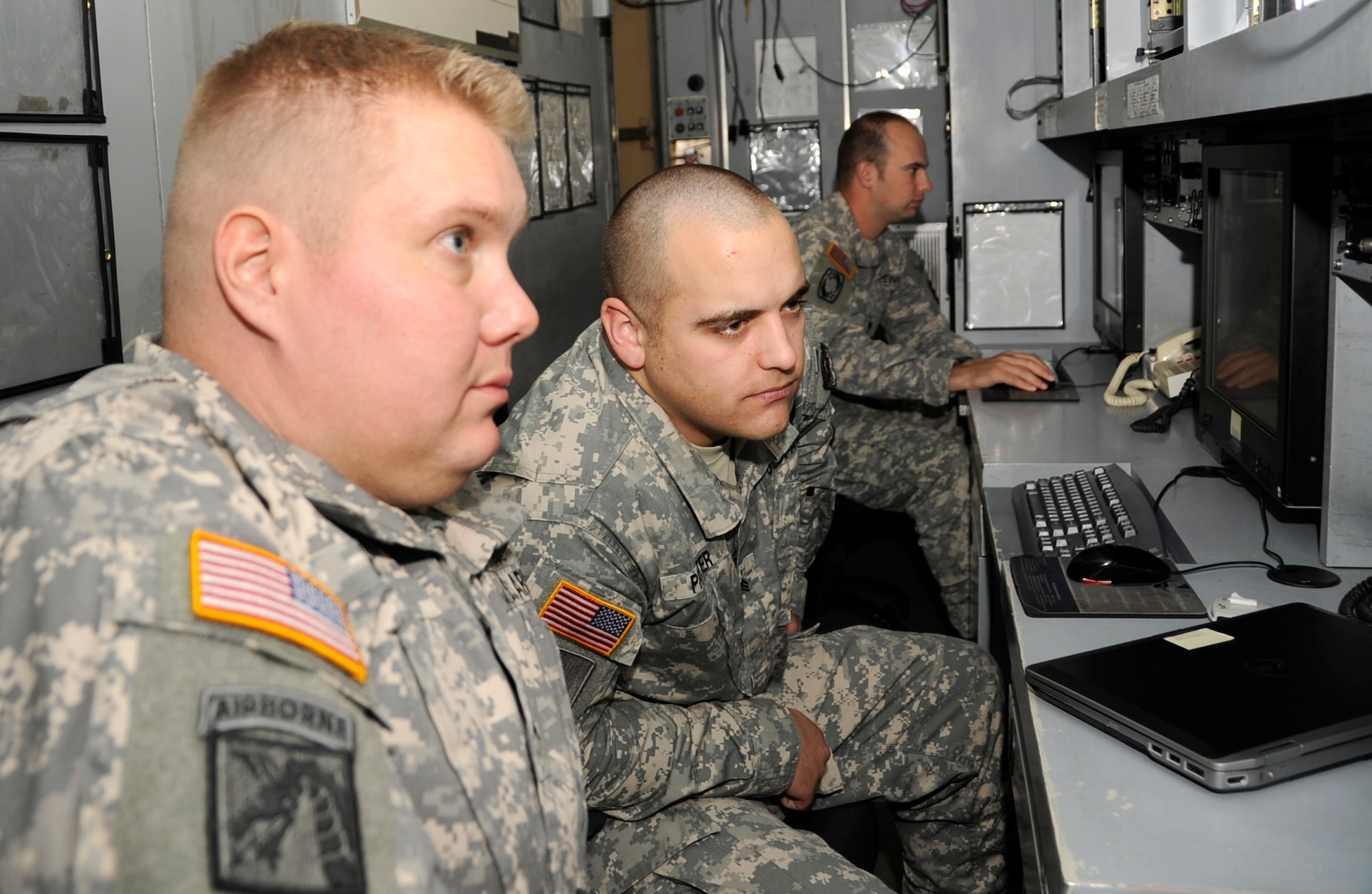 U.S. Army Cpl. Hans Heyer, Delta Detachment 1st Base Company Joint Tactical Ground Station operator, left, and Sgt. Keith Prater, Delta Detachment 1st Base Company JTAGS early warning systems operator, monitor for possible ballistic missiles inside the operational shelter at Misawa Air Base, Japan, July 17, 2013. The mission requires 24-hour monitoring to ensure the safety of the United States and its allies. (U.S. Air Force photo by Airman 1st Class Kaleb Snay)