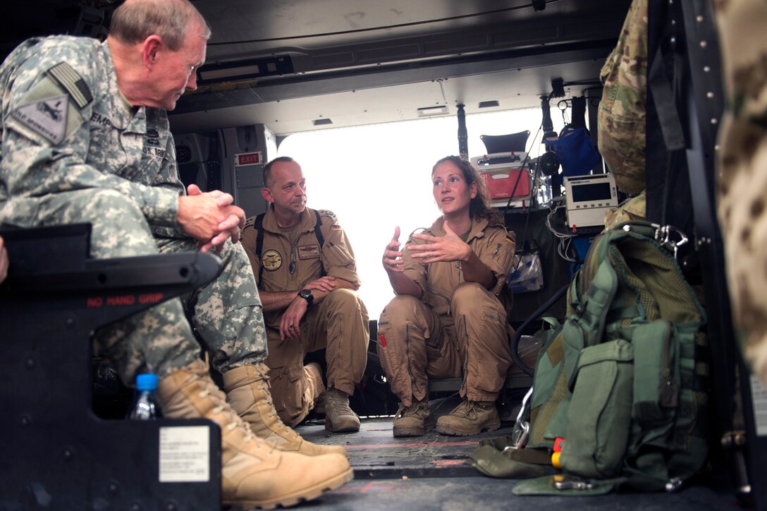 U.S. Army Gen. Martin Dempsey, left, chairman of the Joint Chiefs of Staff, talks with German air medical evacuation soldiers assigned to the International Security Assistance Force for Regional Command North, about the KC-135 mission in Mazar-e-Sharif, Afghanistan, July 21, 2013.  
