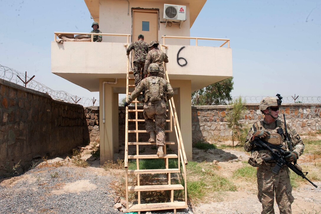U.S. Army soldiers take a tour of the Afghan National Army’s guard tower on former Forward Operating Base Shinwar in Nangarhar province, Afghanistan, July 6, 2013.