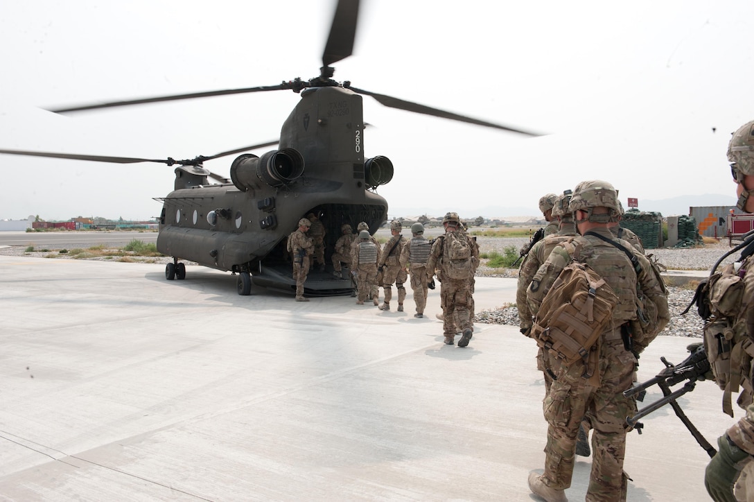 U.S. soldiers board a CH-47 Chinook helicopter on Forward Operating Base Fenty, Nangarhar province, Afghanistan, to travel to former Forward Operating Base Connolly to meet with Afghan National Army personnel, July 7, 2013. The soldiers are assigned to the 101st Airborne Division's 1st Squadron, 32nd Cavalry Regiment, 1st Brigade Combat Team.