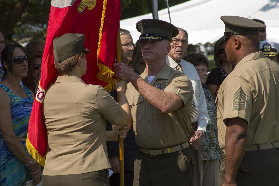 NORFOLK (July 19, 2013) – Col. Susan Seaman passes the organizational colors of Headquarters and Service Battalion, U.S. Marine Corps Forces Command, to Col. Paul Ryan during a change of command ceremony July 19. The passing of the colors signifies the official changeover of command and is a time honored tradition in the Marine Corps.