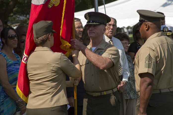 NORFOLK (July 19, 2013) – Col. Susan Seaman passes the organizational colors of Headquarters and Service Battalion, U.S. Marine Corps Forces Command, to Col. Paul Ryan during a change of command ceremony July 19. The passing of the colors signifies the official changeover of command and is a time honored tradition in the Marine Corps.