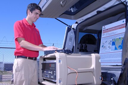 Michael O'Brien, Space Integrated Government Solutions intern, demonstrates the Spacenet Emergency Communications System at the Coalition Warrior Interoperabilty Demonstration in Colorado Springs June 15. CWID is part exercise, part vendor demonstration, where companies offering new technologies can demonstrate their products in a realistic environment. The ECS is a portable communications hub that can be integrated into mobile command vehicles to provide field personnel with access to the Internet, land mobile radios, public telephone networks and secure private networks. The system has been used in Haiti and more recently in the aftermath of the Joplin, Mo., tornadoes. 