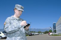 Army National Guard Sgt. Stephanie Peavy, 244th Army Liaison Team from Chicago, works with a "Life Ring" cell phone being demonstrated at the Coalition Warrior Interoperability Demonstration in Colorado Springs June 15. CWID is part exercise, part vendor demonstration, where companies offering new technologies can demonstrate their products in a realistic environment. The Life Ring is a cell phone system that combines a GPS and satellite communications, allowing continuous communication and tracking through a G3 network cell phone regardless of conditions on the ground. This allows first responders in a disaster situation to maintain contact with their organization leadership even if cell towers in the area have been destroyed.
